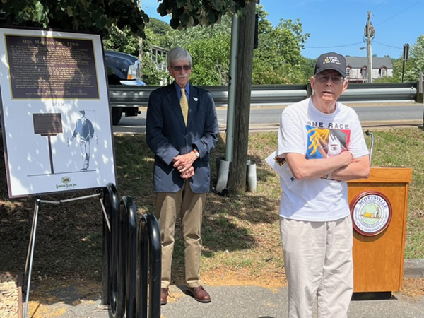 Mayor Ron Smith beside MInerva's plaque as Chris Wade speaks