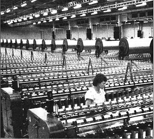 Mary J. Goodman tending the spindle machine at the Rubber Plant